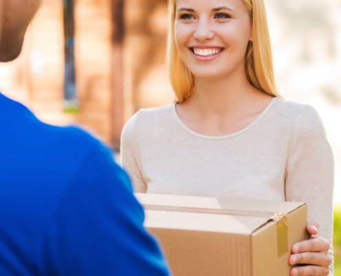 Christmas deliveries man giving box to woman